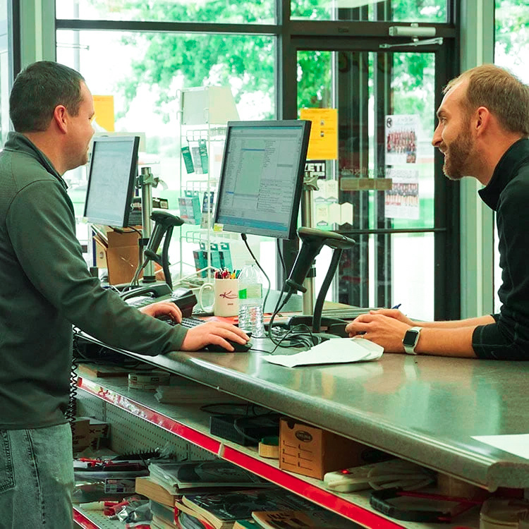 An auto part employee helping a customer.